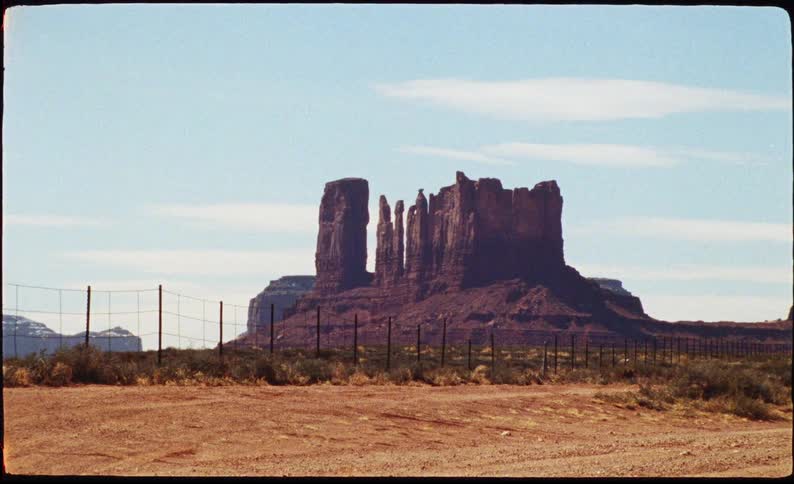 Towering sandstone formations rise from the desert floor in Monument Valley