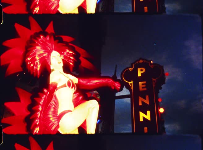 Casino neon sign with an illuminated female figure at night