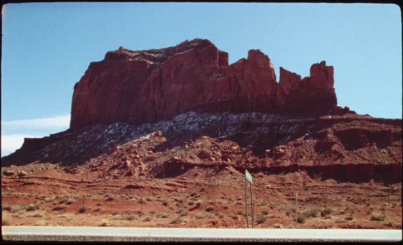 Rock formations on the side of a desert road
