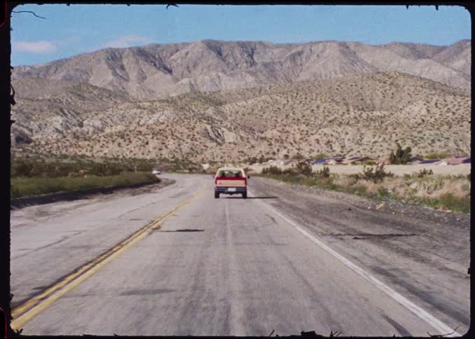 Cars traveling on a highway surrounded by mountains