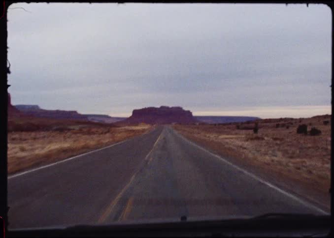 The vehicle travels on the desert highway