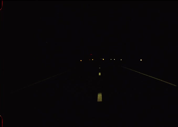 Driving down a road at night
