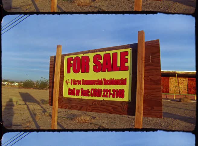 A close up of a for sale sign on a rural area