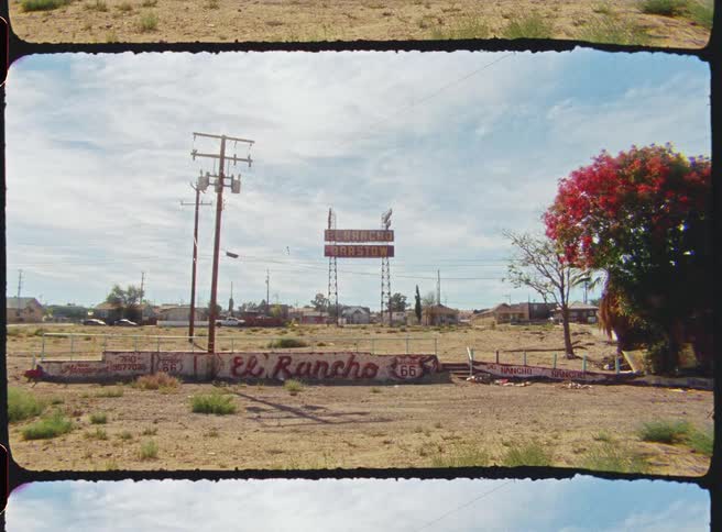This video features a static vintagestyle shot of the weathered el rancho motel sign along route 66 the scene captures a nostalgic desert atmosphere with sunbleached colors and a clear blue sky