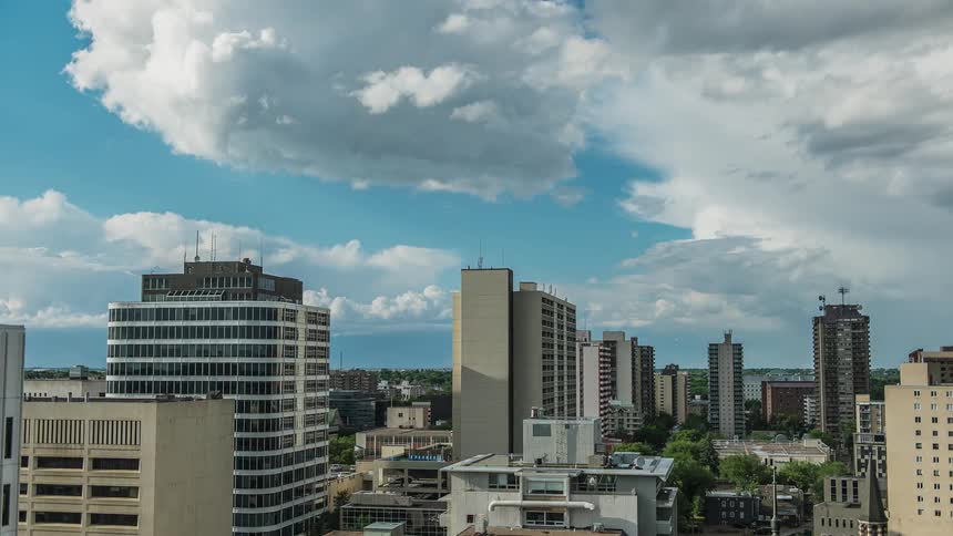 Clouds float over city buildings
