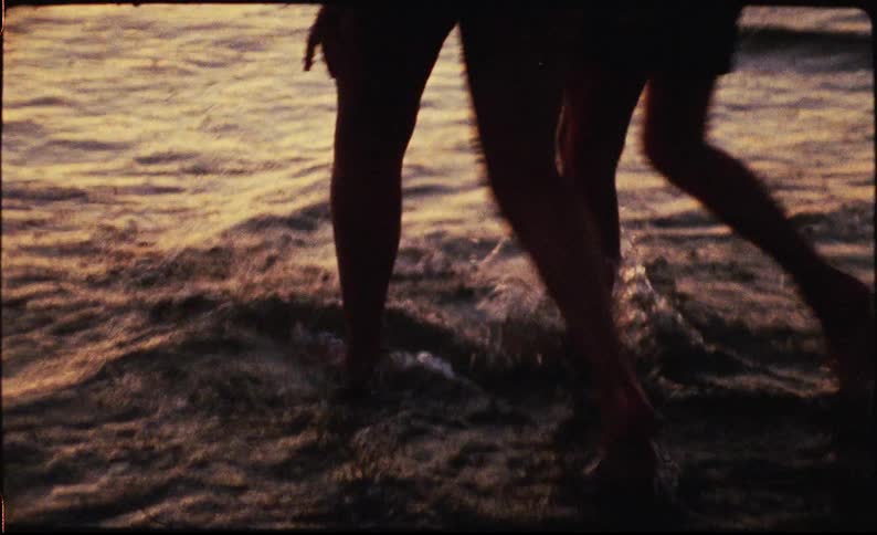 A man and woman walking in the beach