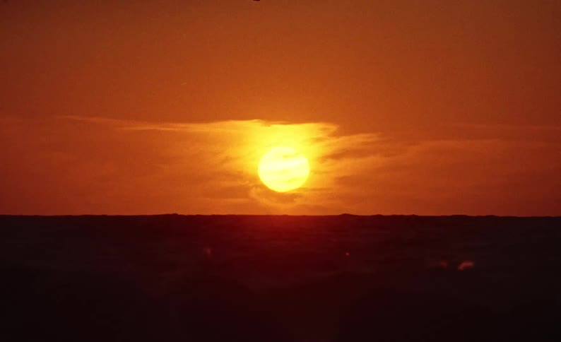 Rough ocean waves with the sunrise on the horizon