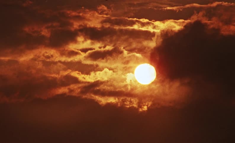 Moon amidst the reddish clouds