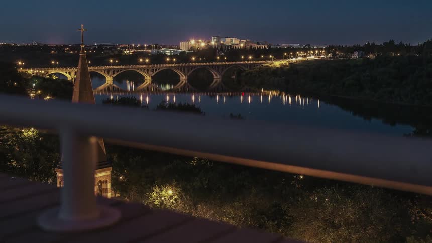 The water is calm at night by the bridge