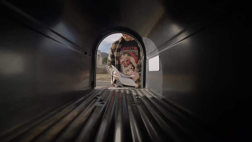 A man reaching into a mailbox to get letters