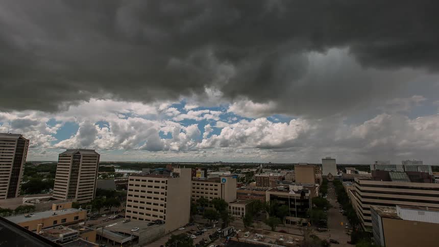Time lapse of storm clouds moving over a large city