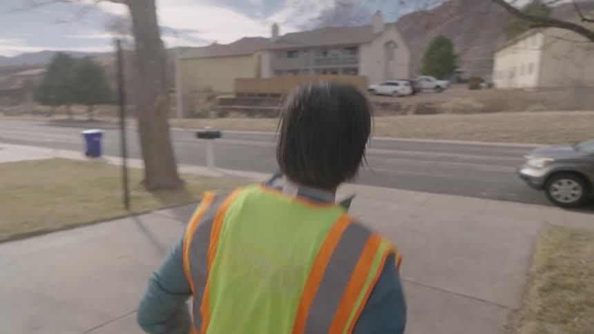 The man delivers a package and runs back to his car