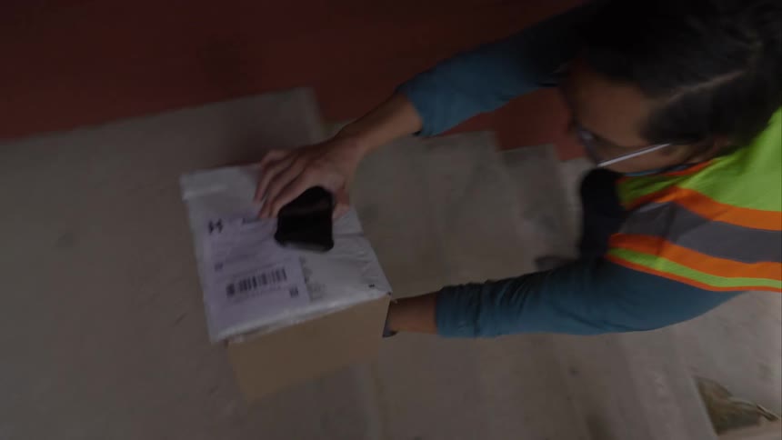 A man delivering a package to a porch