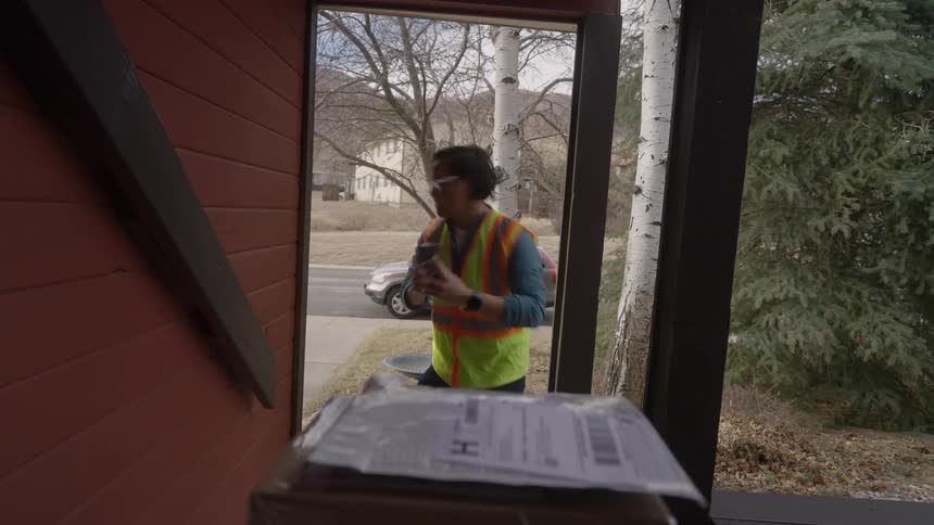 The man delivers packages to the home