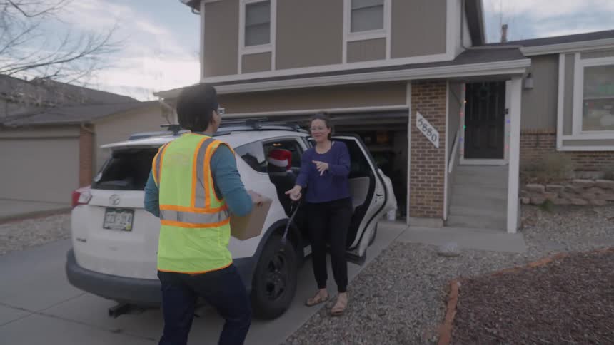 The man delivers a package to a woman