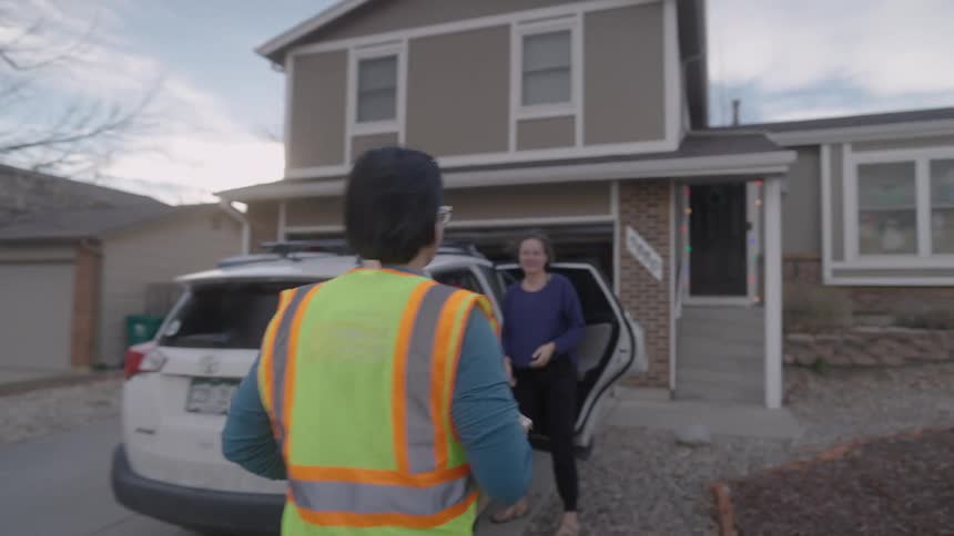 Man handing a box to a woman