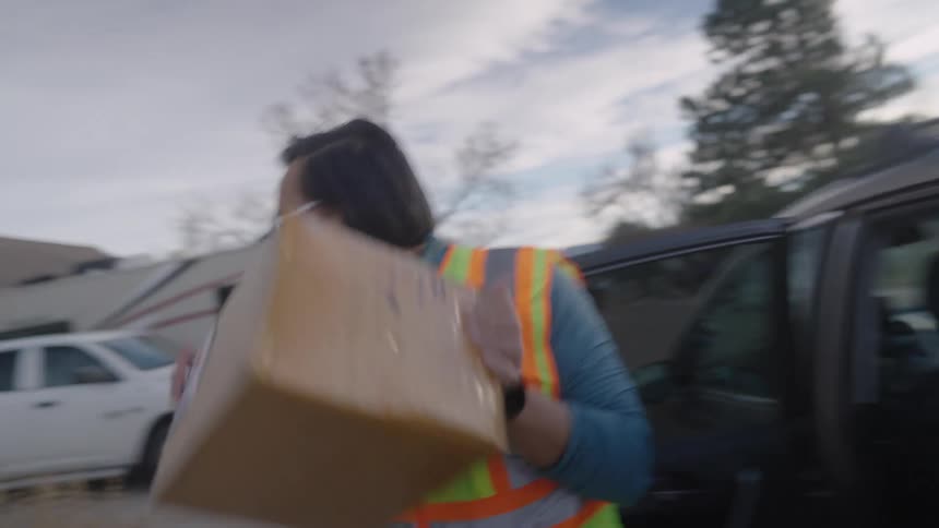 The delivery driver rushes the package to the home