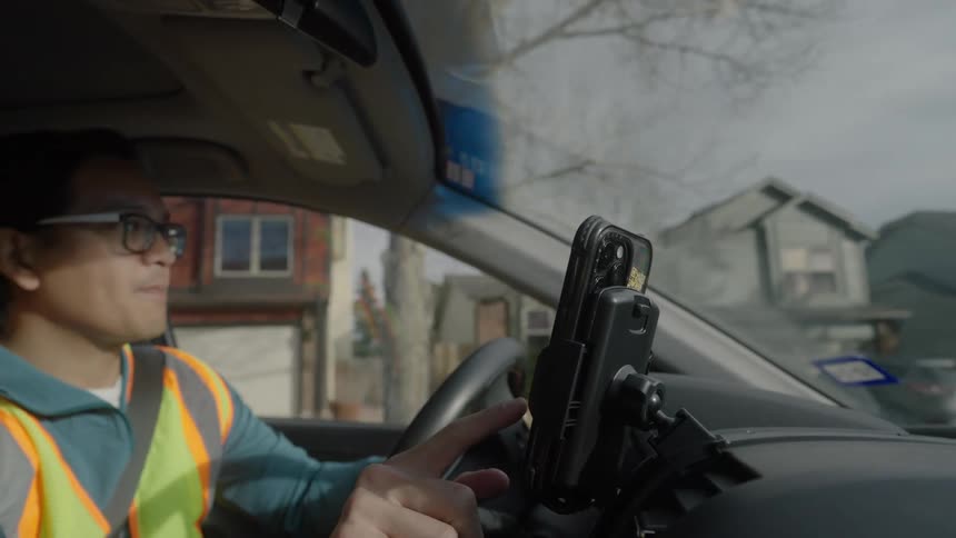 A man driving a car to deliver packages
