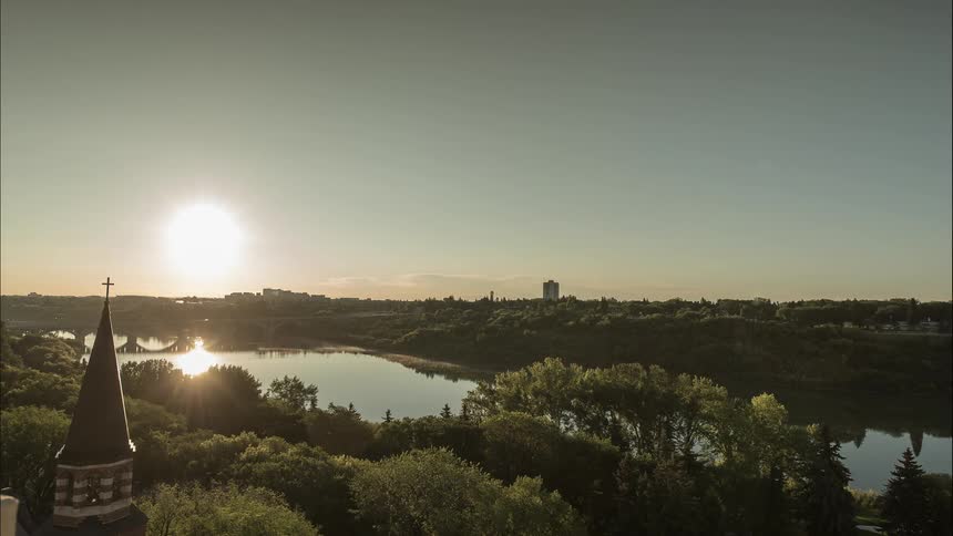 The sun shines brightly over a river