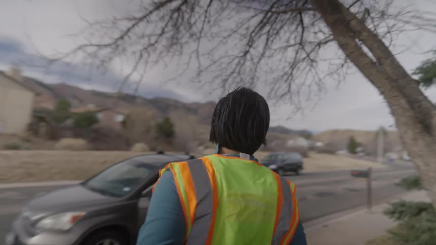A delivery driver running back to his car after dropping off a package