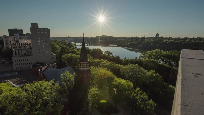 The sun shines over city buildings