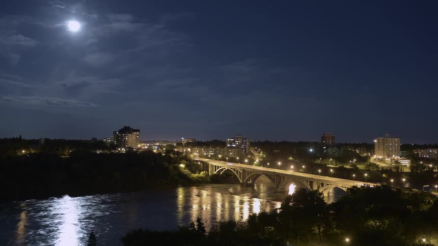 Cars travel over the bridge at night
