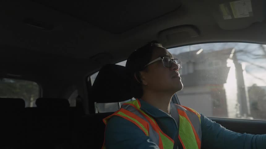 Man in vest driving and having fun