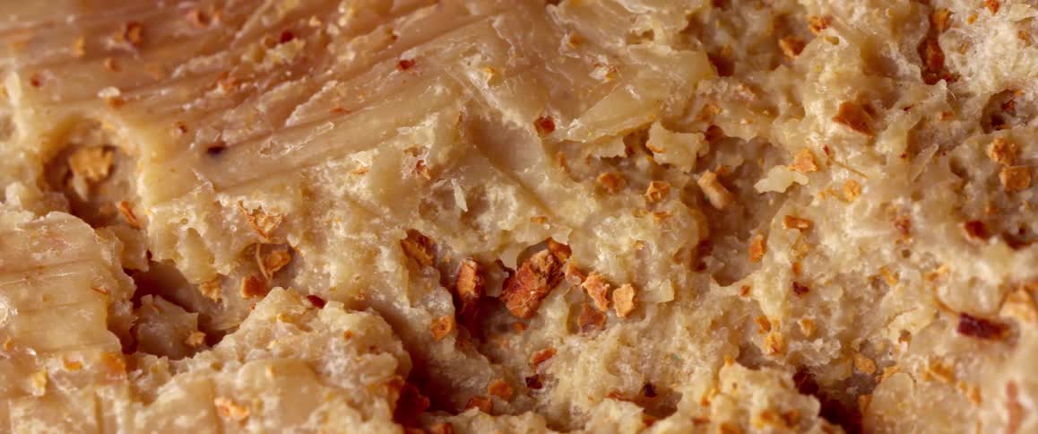 A slice of peanutbuttercovered bread resting on a surface