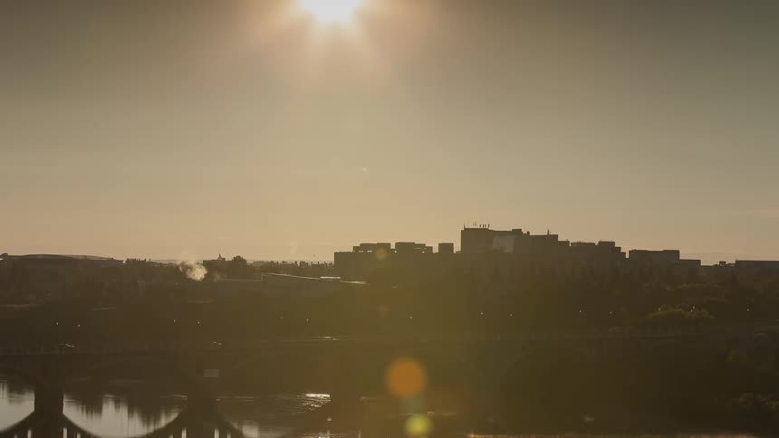 The sun slowly rises in the distance