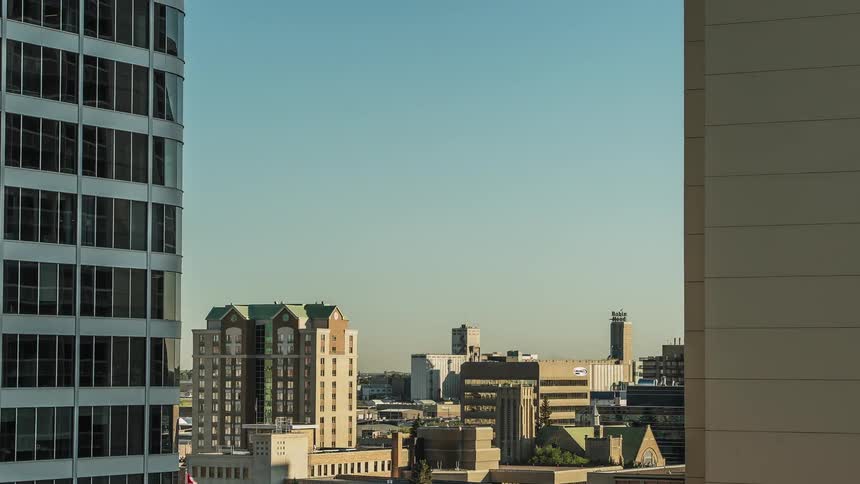 The sky is clear between these two buildings
