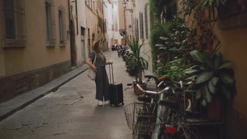 The woman is looking at her phone in the city