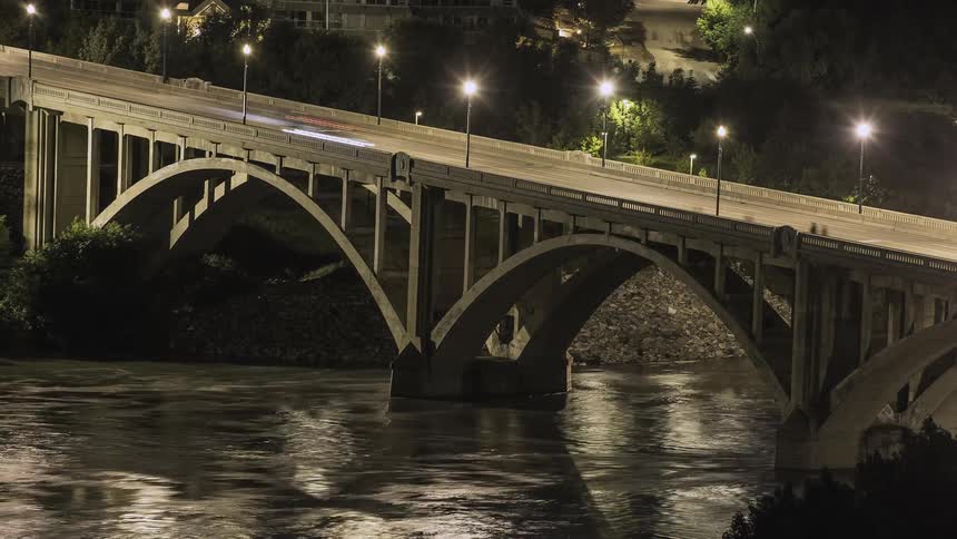 Cars, and people travel over the bridge