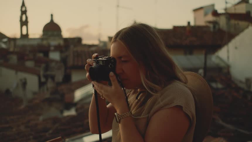 A woman taking photos with a camera