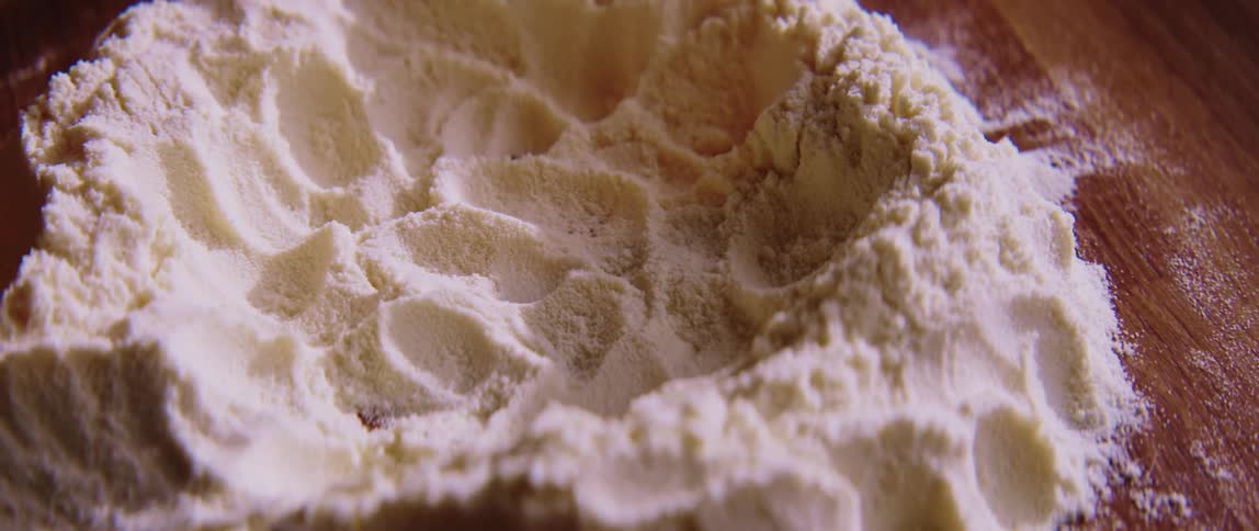 A view of some egg being added to flour