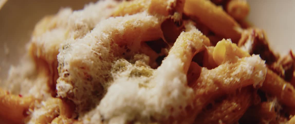 Fine shredded cheese tops a pasta dish