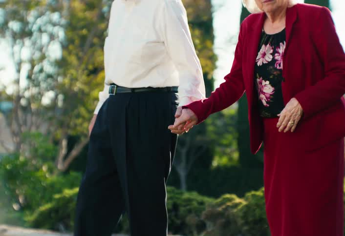 Elderly couple holding hands outdoors