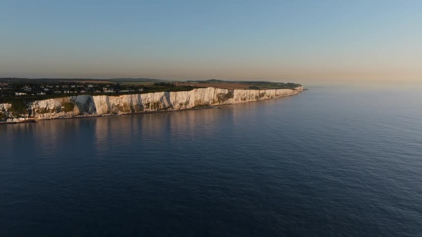 Houses and buildings on the white chalk cliffs along the coast of dover england