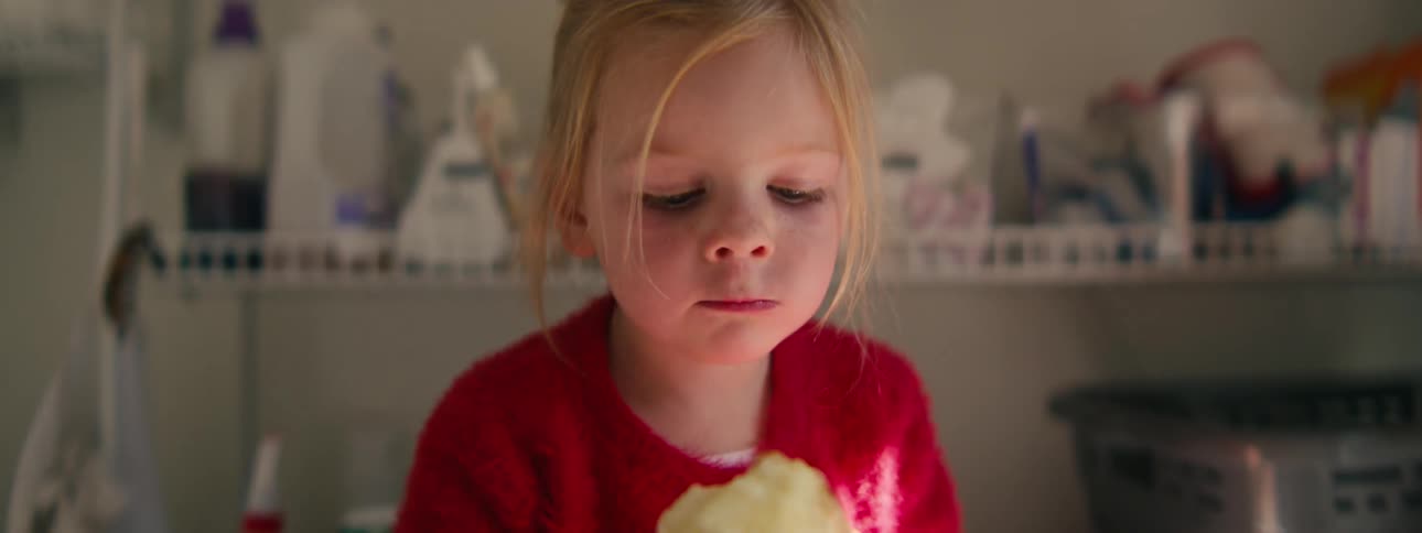 A girl eating an apple in a room