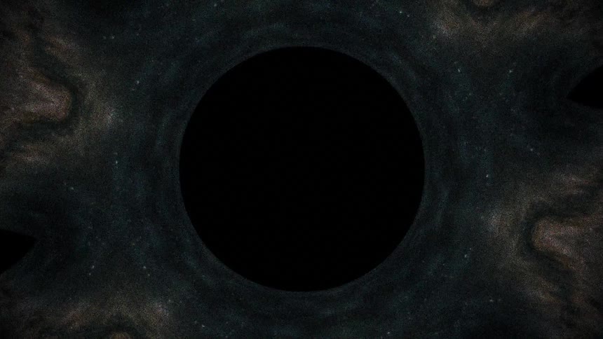 Dark circular formation occupies the center of a textured surface with concentric patterns around it