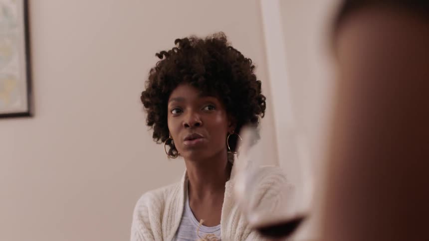 A woman leans forward listening and talking