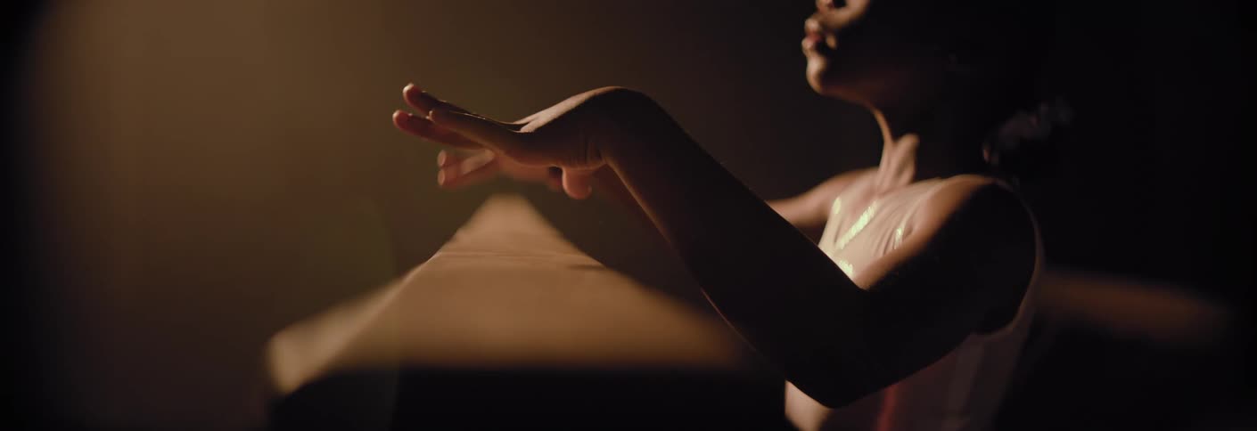 A girl getting onto a balance beam