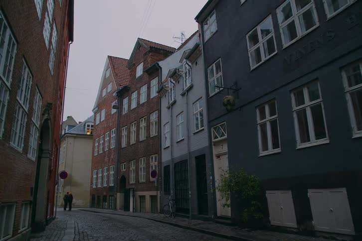 People are standing at the end of the small road