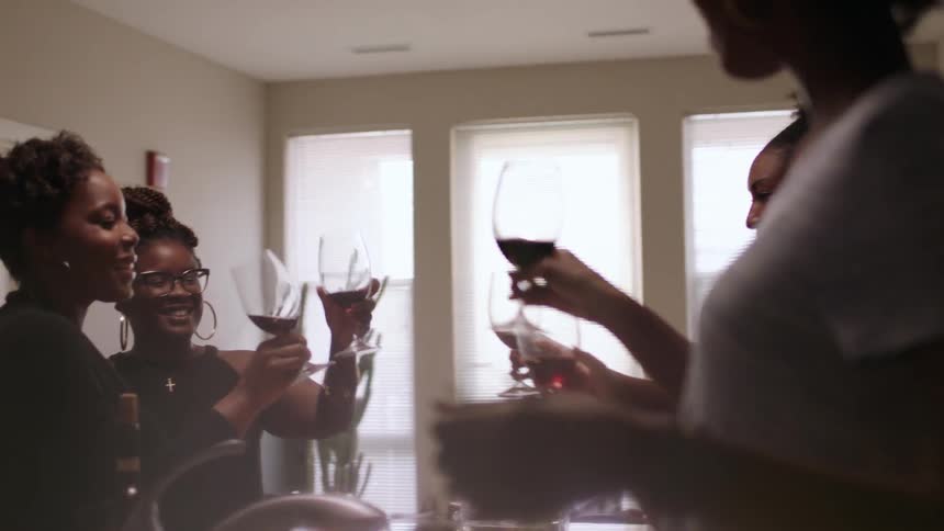 Women toast glasses together