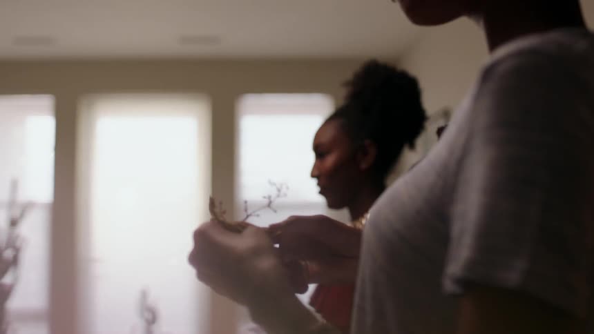 The women eat grapes around the table