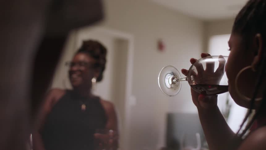 Women talk and drink wine