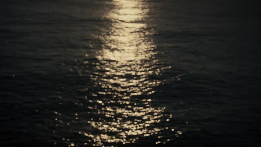 Sunlight reflects on the water as it ripples and waves