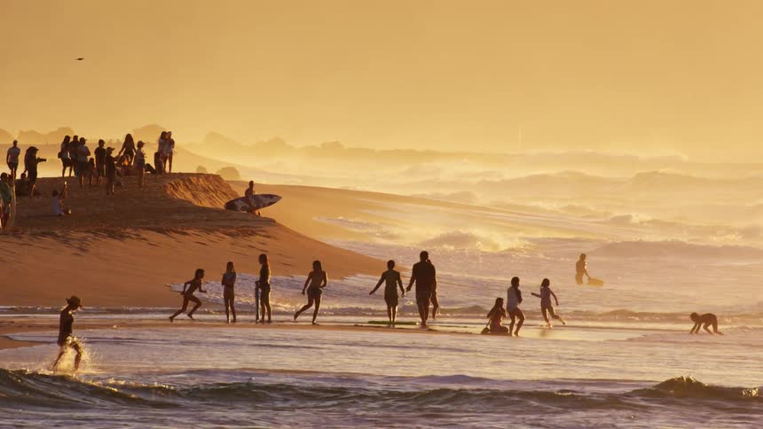 People are playing and running on the beach