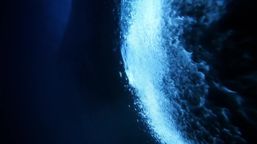 The surfer glides over the wives above the water