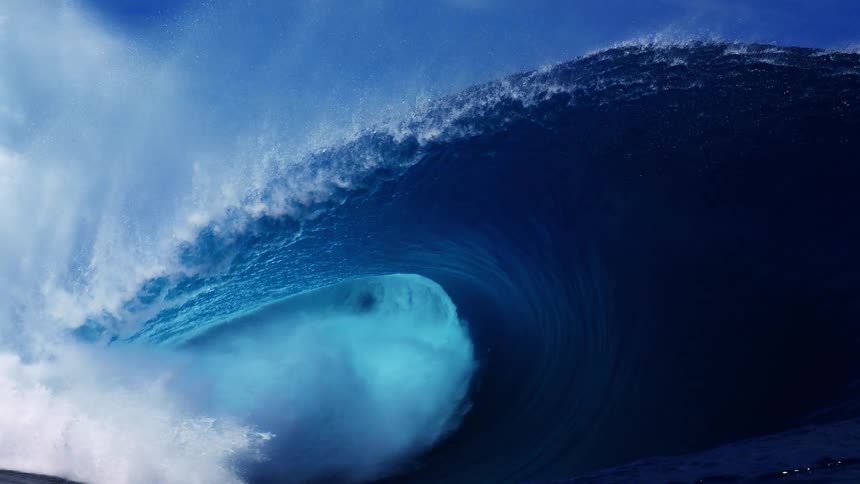 The large blue wave crashes in the ocean