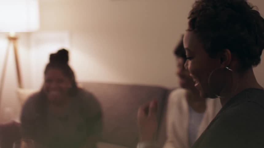 Women are playing a game in the living room
